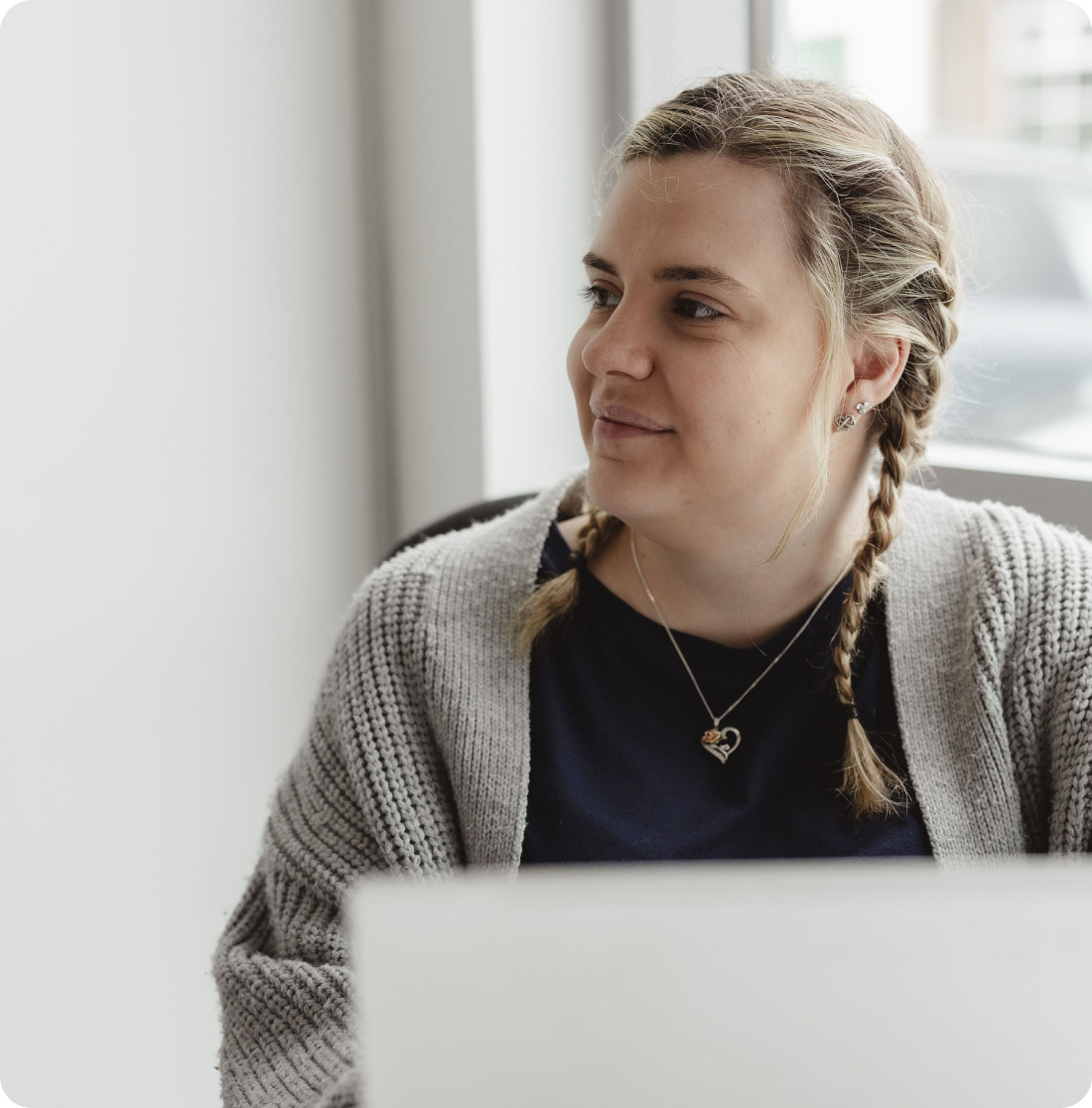 Onecom employee on laptop looking left